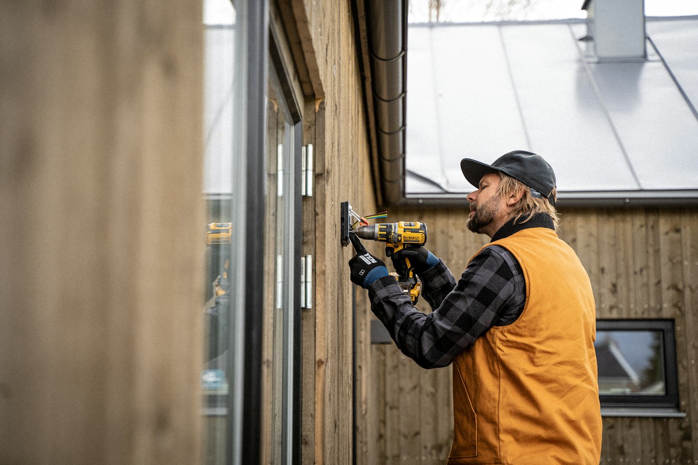 Technician installing equipment on a building