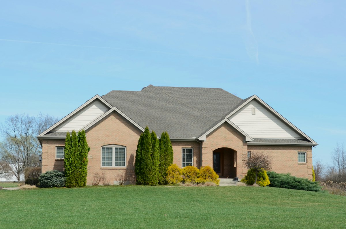 Brick family home with a front lawn